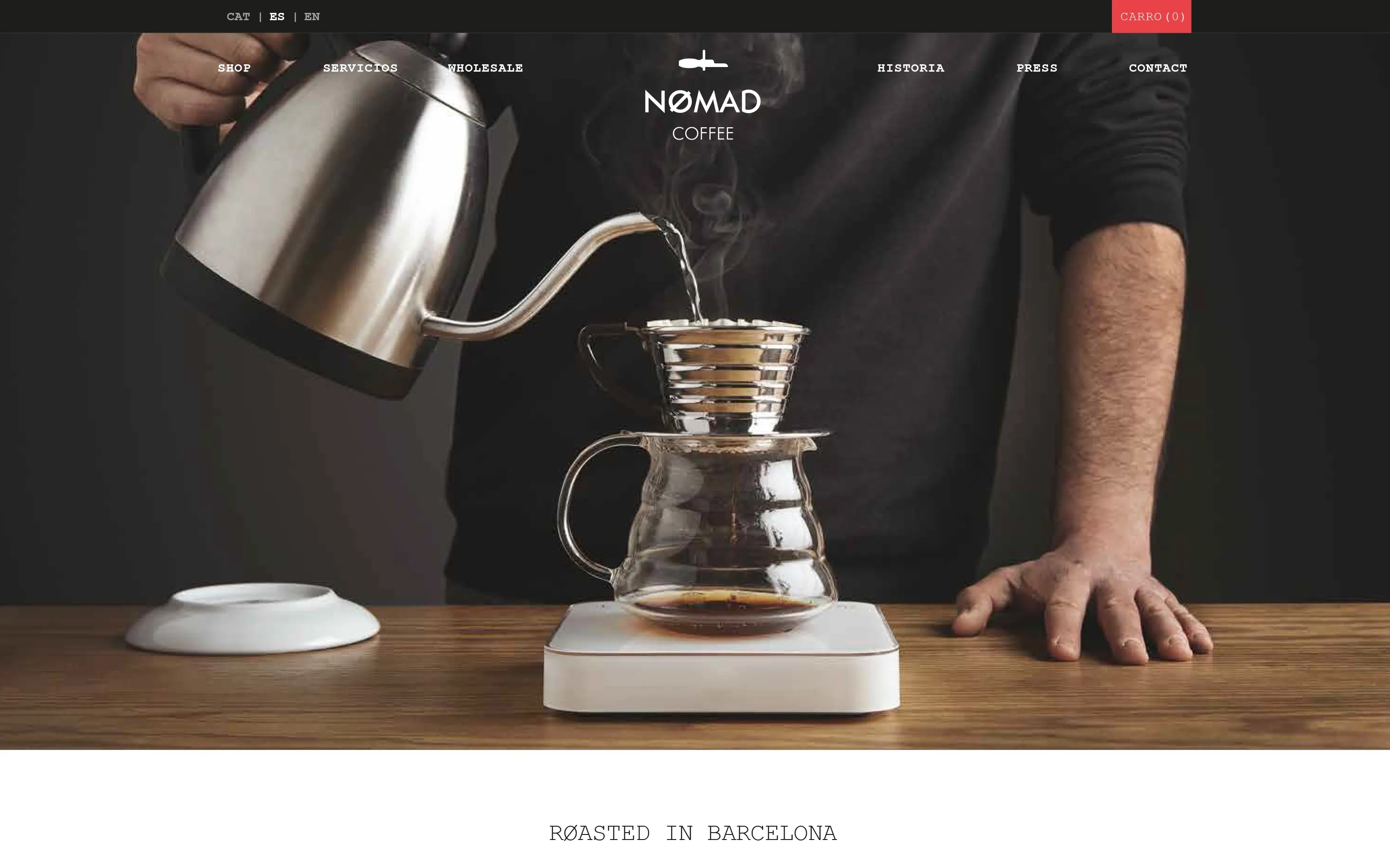 Nømad Coffee website homepage showing a barista pouring filter coffee