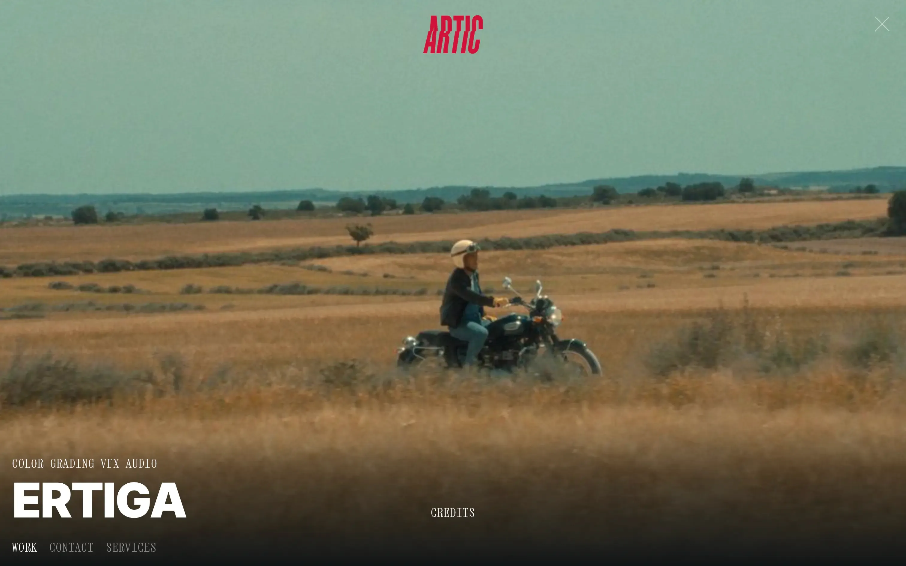 Artic TV project page for Ertiga with a motorcyclist riding across golden fields