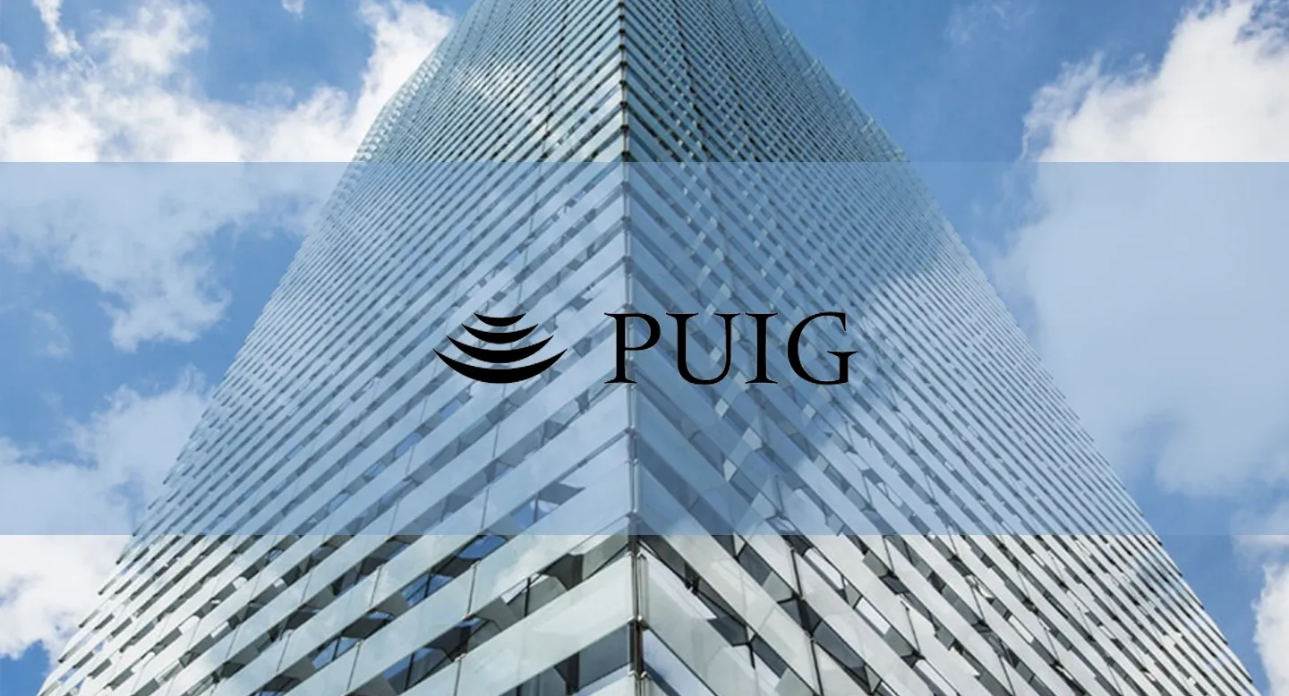 Puig logo over a glass office tower